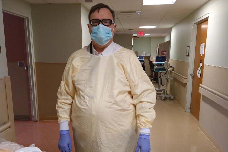 Paul Lehmann, in mask and gloves, stands in hospital.