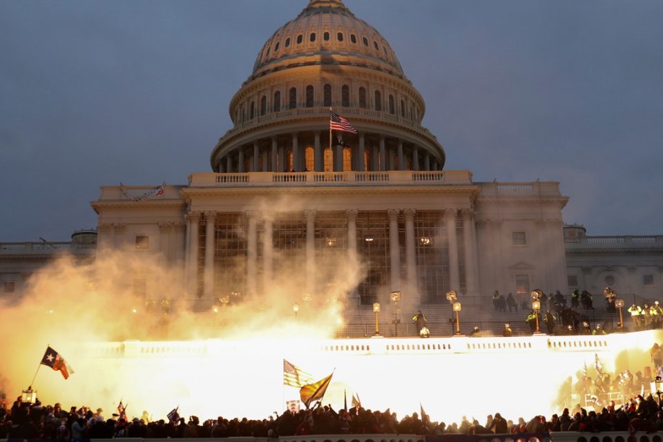 Smoke rises amid mobs assaulting the captiol on January 6, 2021.