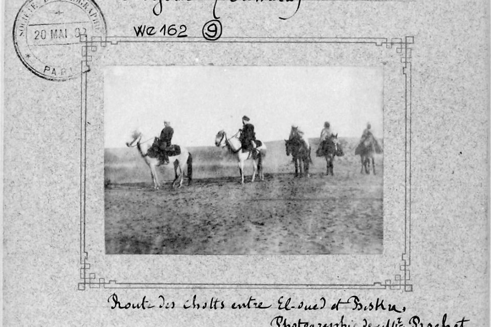 Historical black and white photo graphic of men on horseback in a field.
