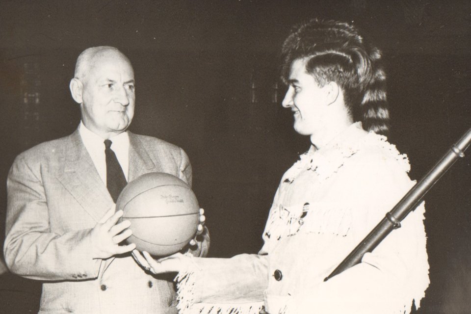 Pioneer mascot handed basketball.