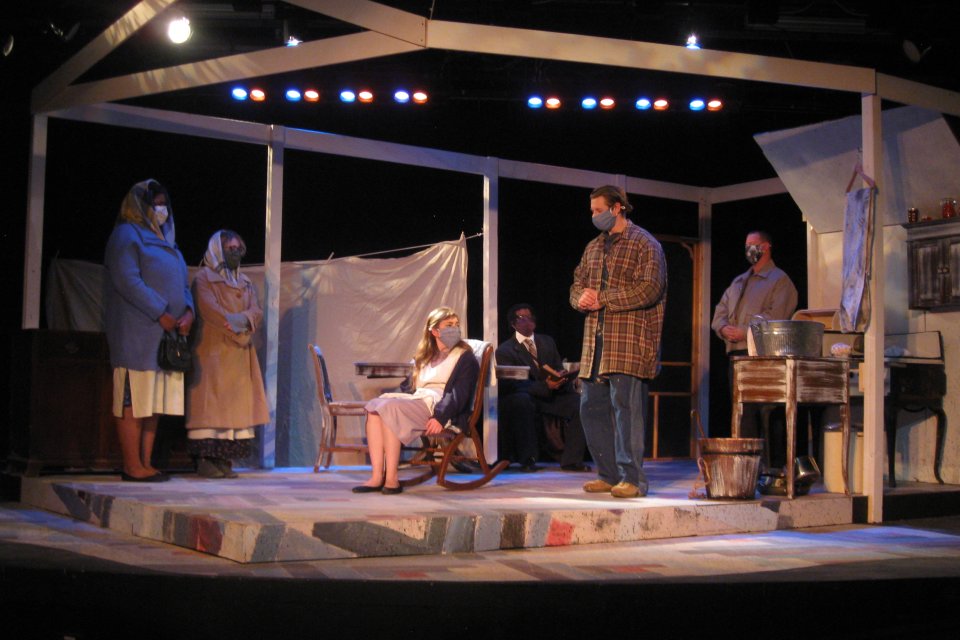 Performers on stage in a scene from Trifles, the Fall 2021 production at Utica College.