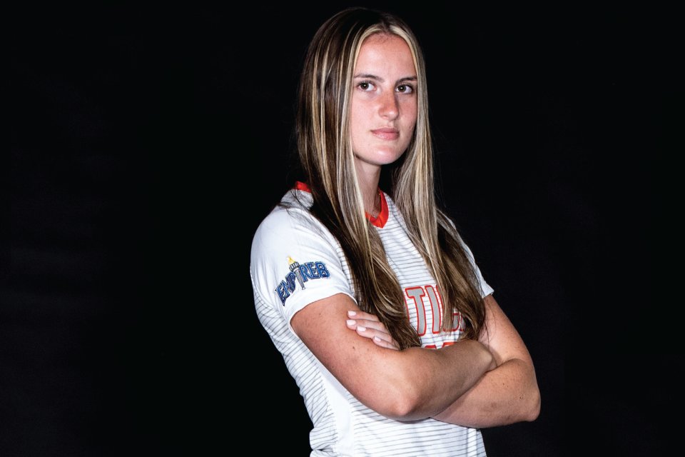 Kela Mochak, Class of 2024, stands with arms folded in soccer uniform.