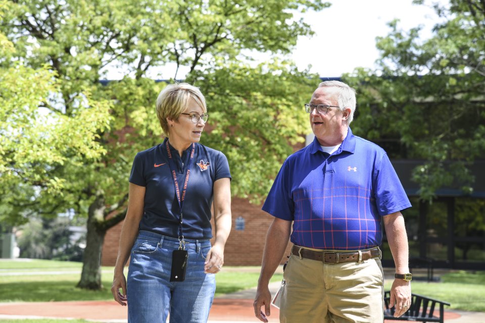 Laura Casamento and Todd Pfannestiel walk along the campus in 2023